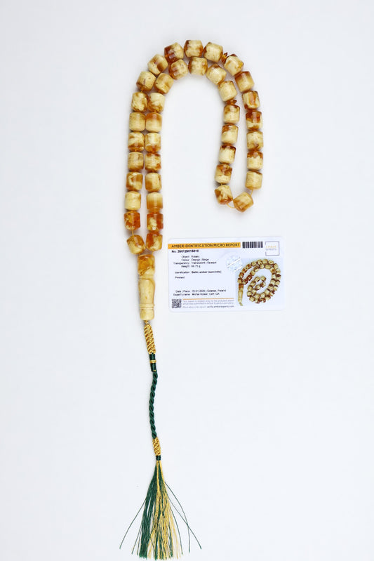 Certified 66g Baltic amber misbaha made of natural succinite with cube-shaped beads in beige and honey tones, finished with green and gold tassel and official amber identification certificate.