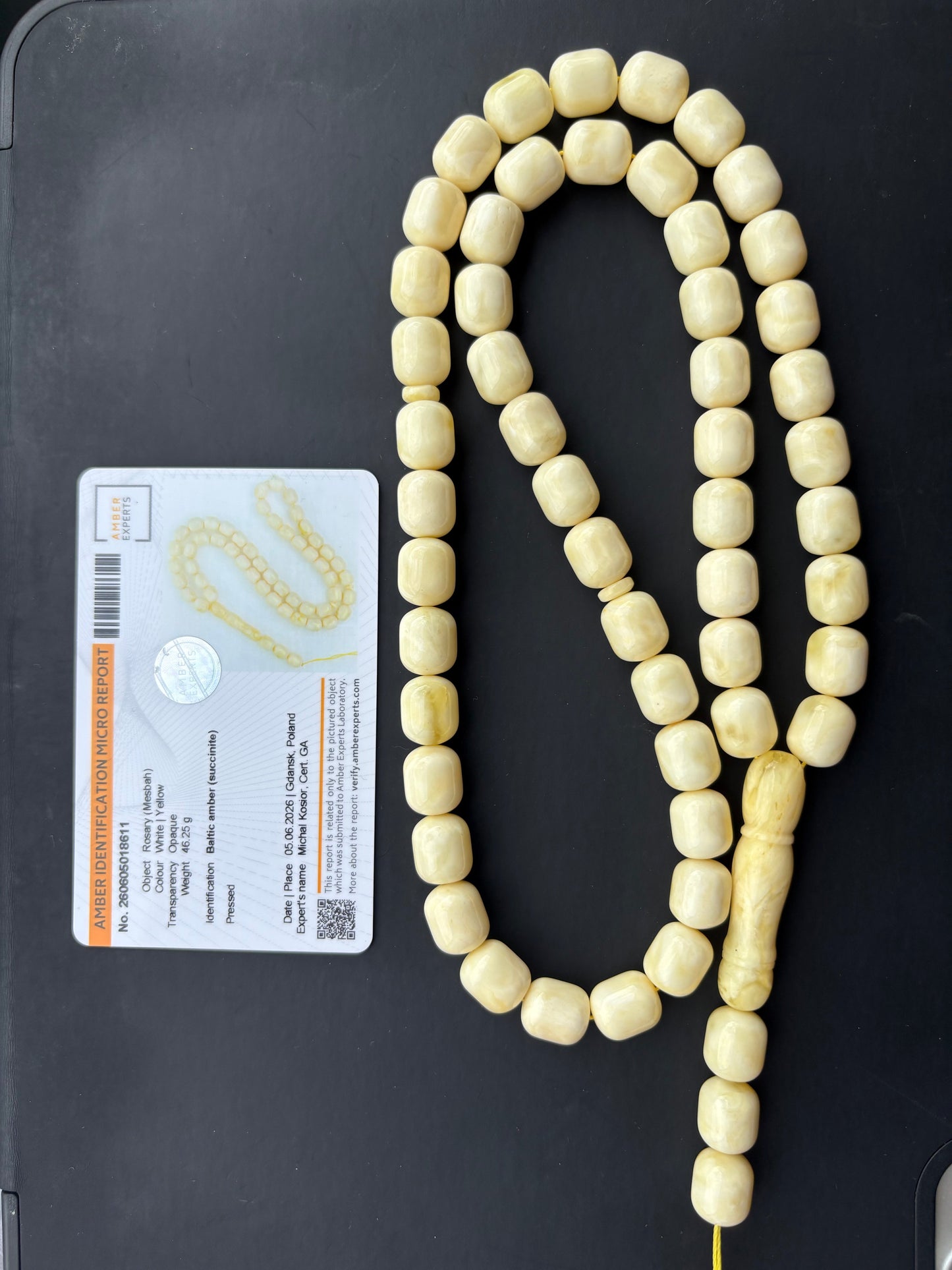 Tetibel Baltic Amber Mesbah rosary featuring 54 certified pressed white and yellow beads measuring 12x10mm, weighing 46.25g, with an official Amber Experts certificate and a minor natural imperfection on the imam topper.