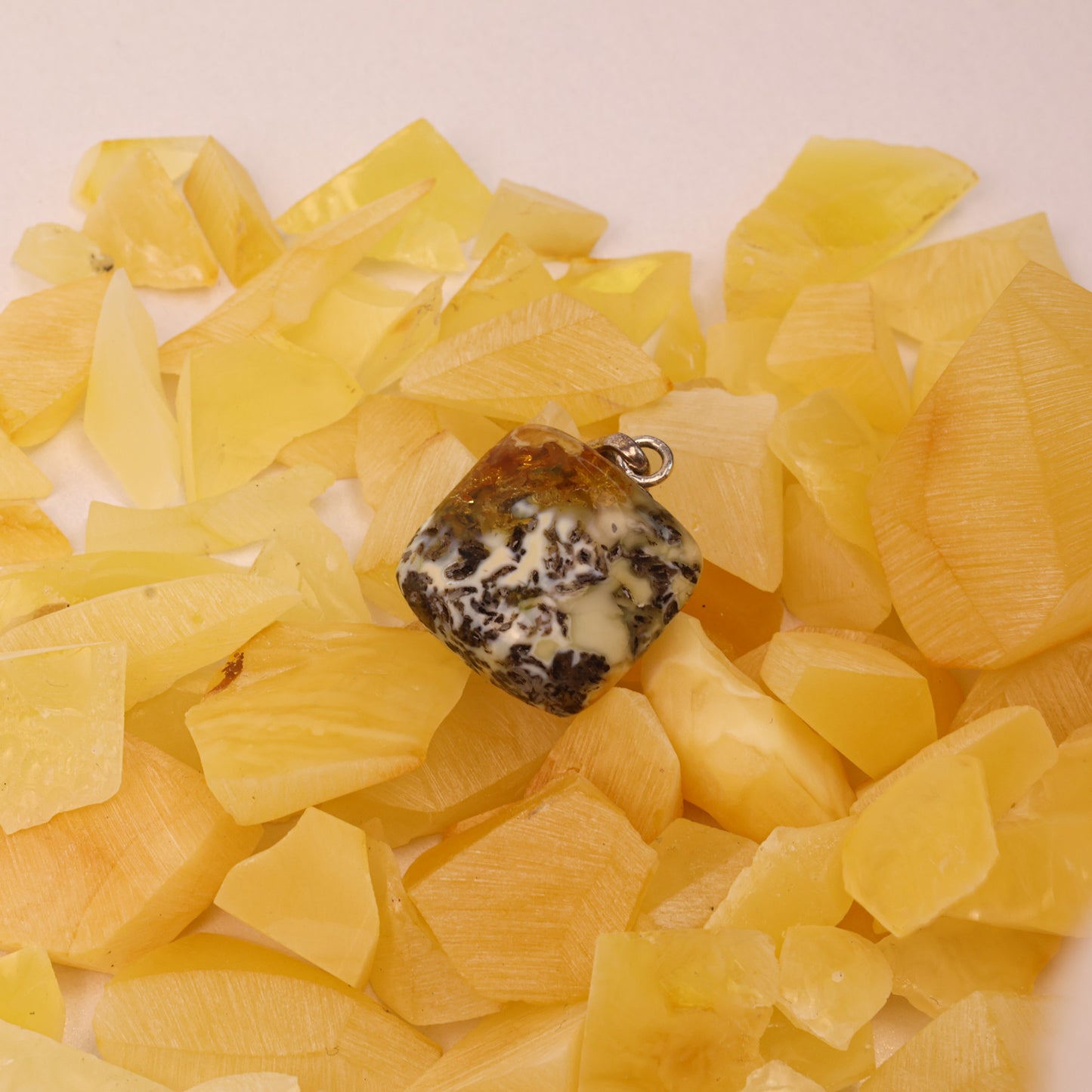 Amber stone pendant on a bed of yellow stones