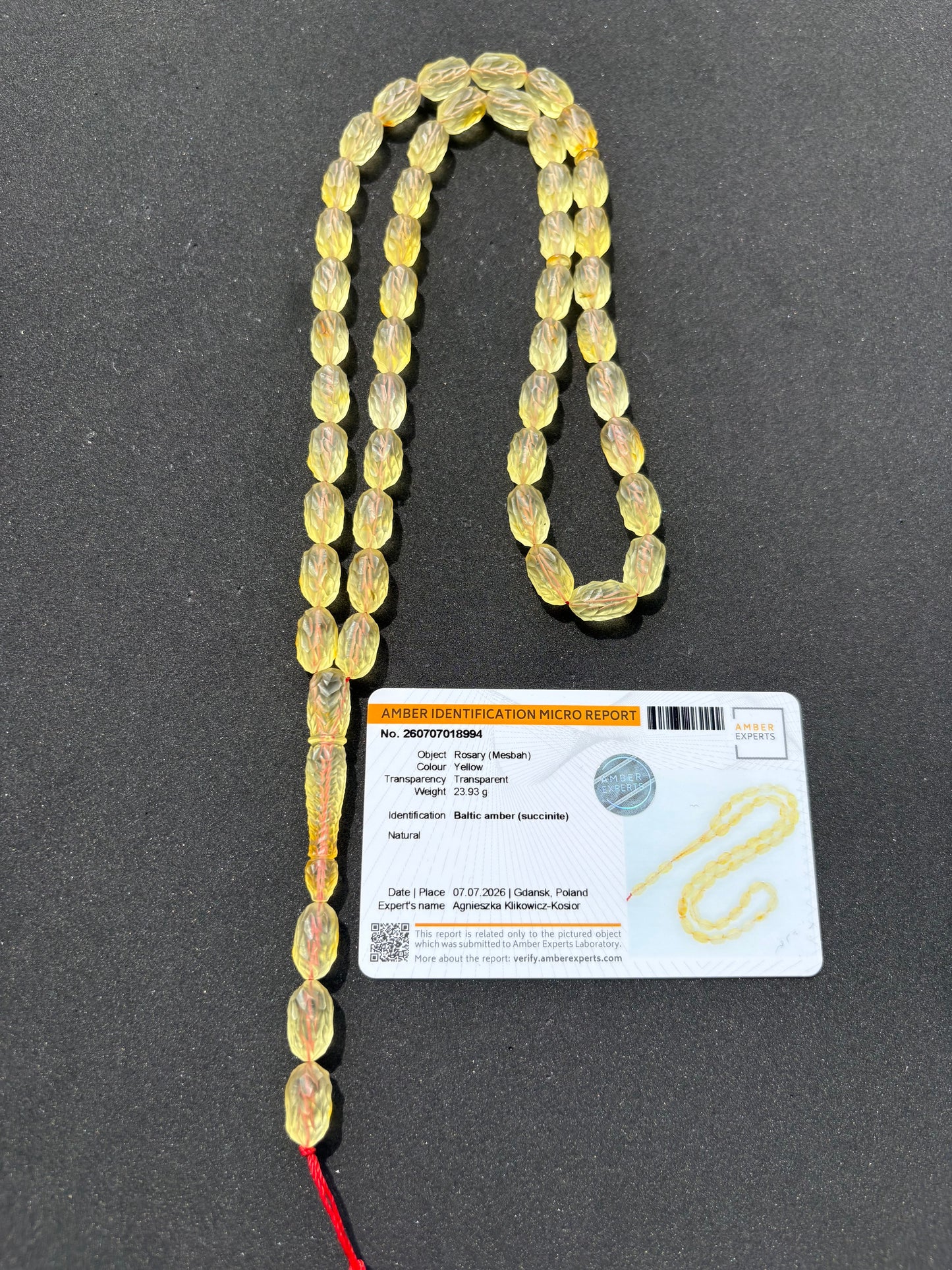 Certified Baltic amber Misbaha featuring transparent carved beads with leaf patterns.