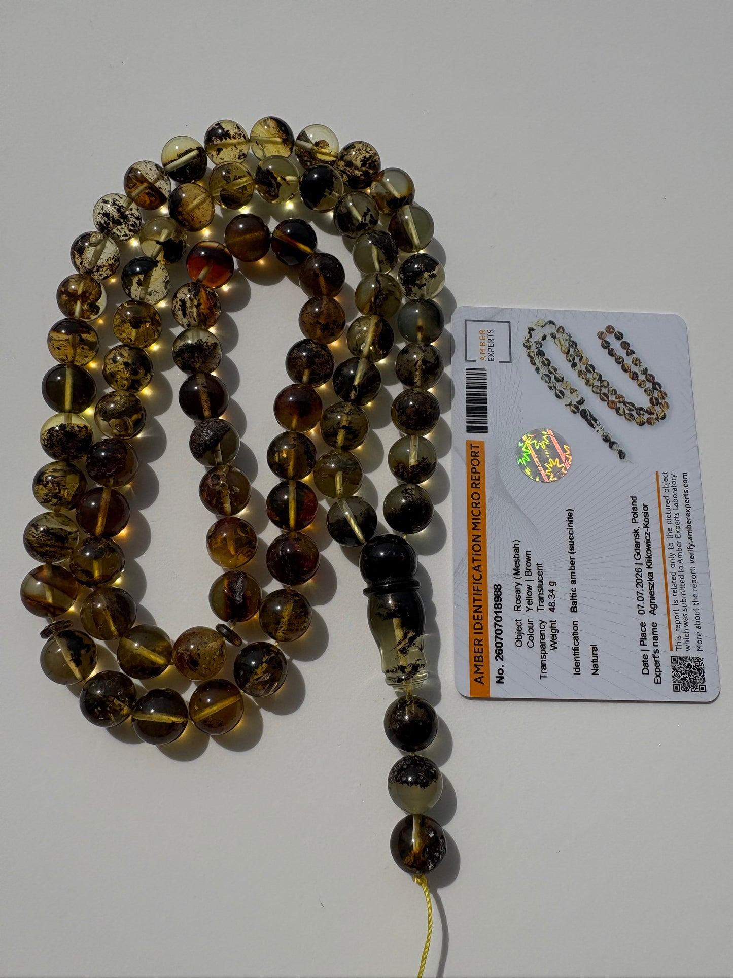 Tetibel genuine succinite amber prayer beads with natural inclusions.