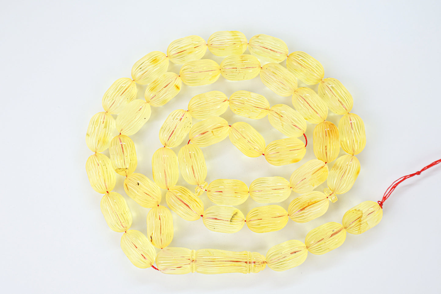Authentic grooved hand-carved yellow Baltic amber misbaha strand complete with matching carved amber imam.