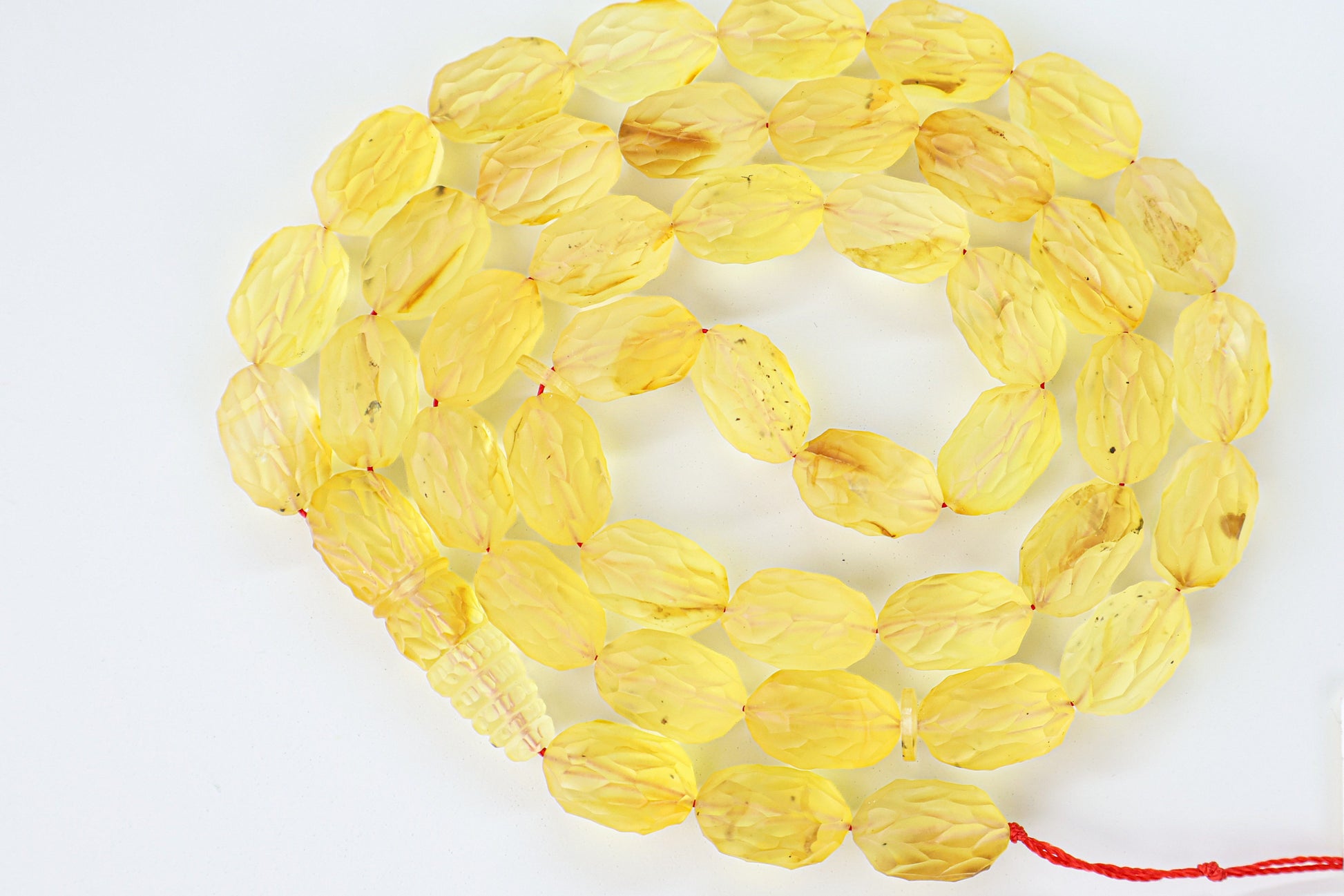Handcrafted yellow and brown succinite amber tasbih featuring 42 authentic 16.5x10.5mm faceted beads with minor natural imperfections, weight 44.66 grams.