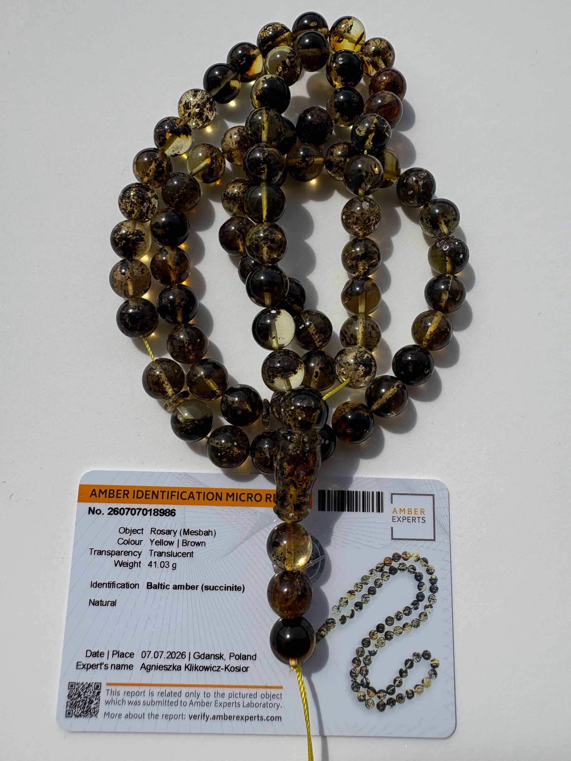 Collector-grade galaxy amber rosary with certificate of authenticity.