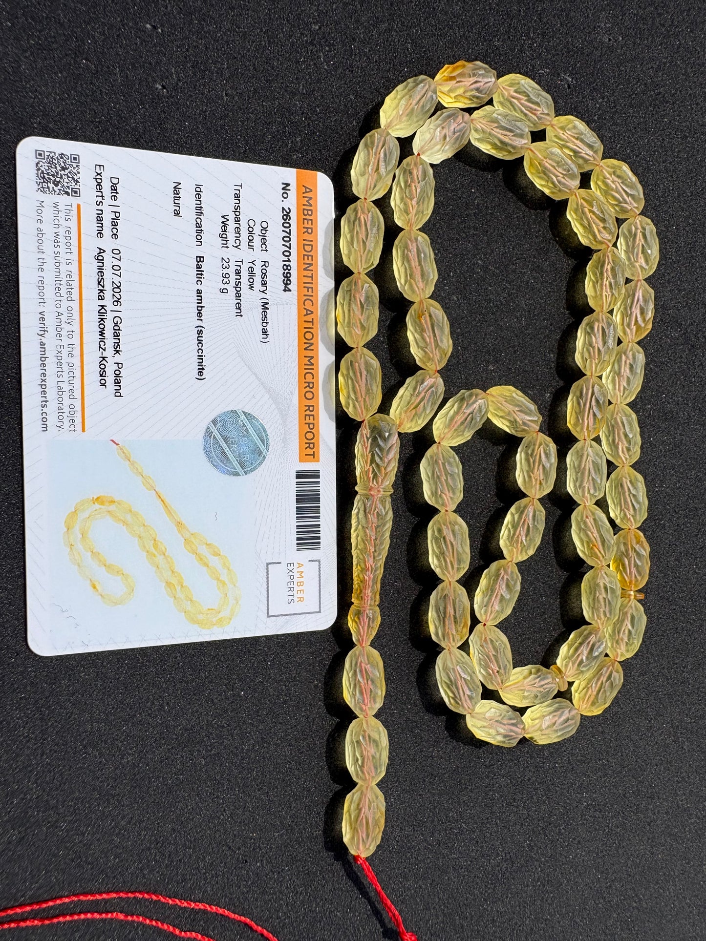 Genuine succinite amber prayer beads with handcrafted decorative carving.