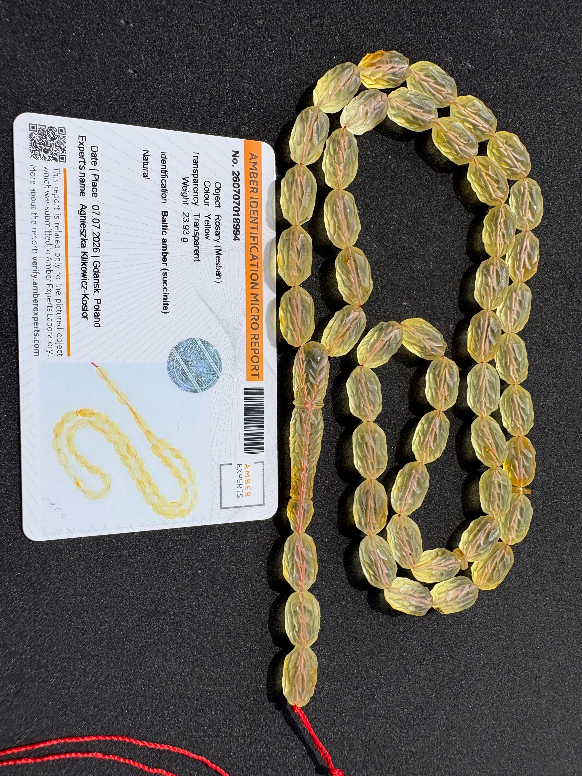 Genuine succinite amber prayer beads with handcrafted decorative carving.