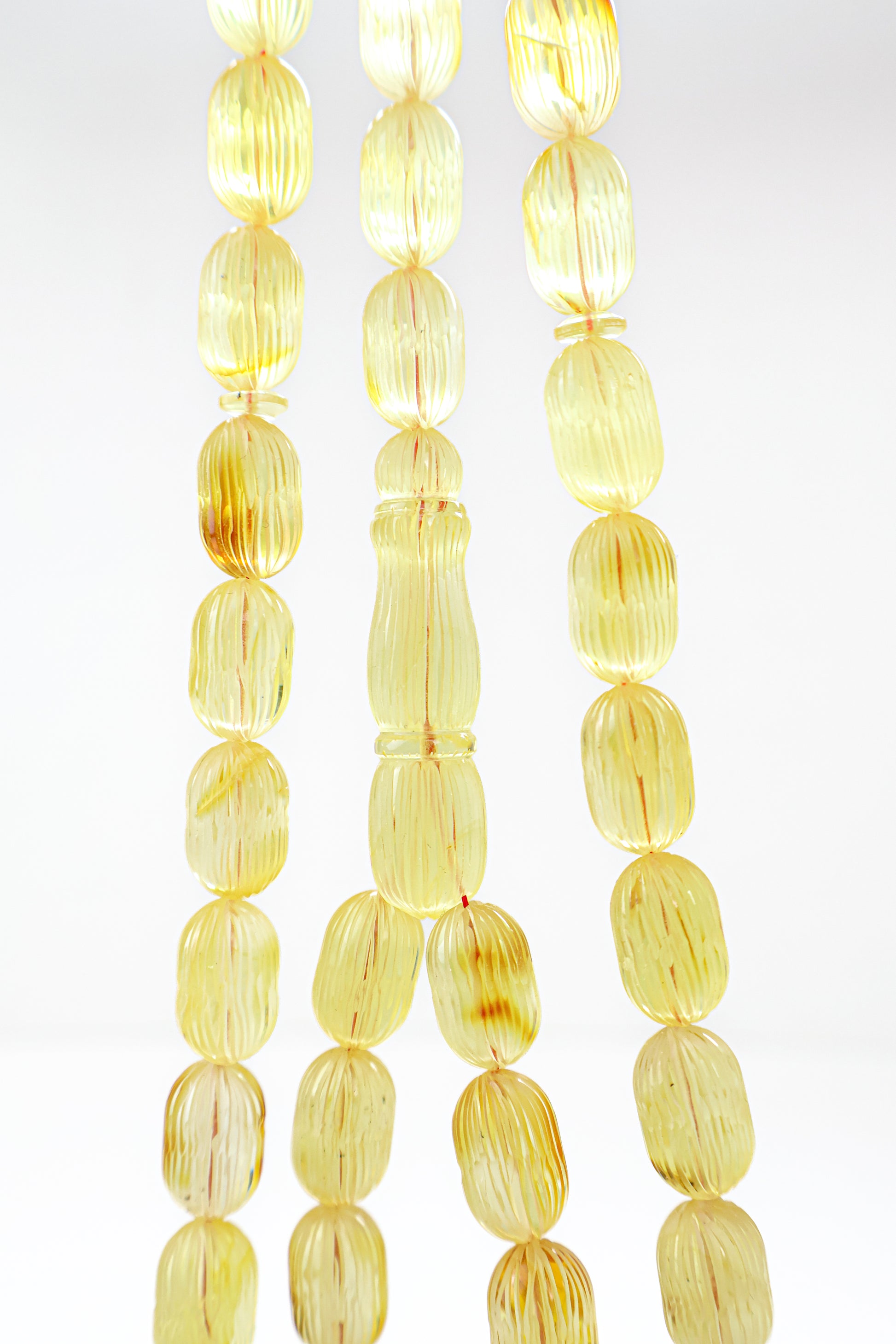 Handcrafted yellow and brown succinite amber tasbih featuring 42 authentic 16.3x10.2mm handmade carved beads with natural inclusions, weight 46.71 grams.
