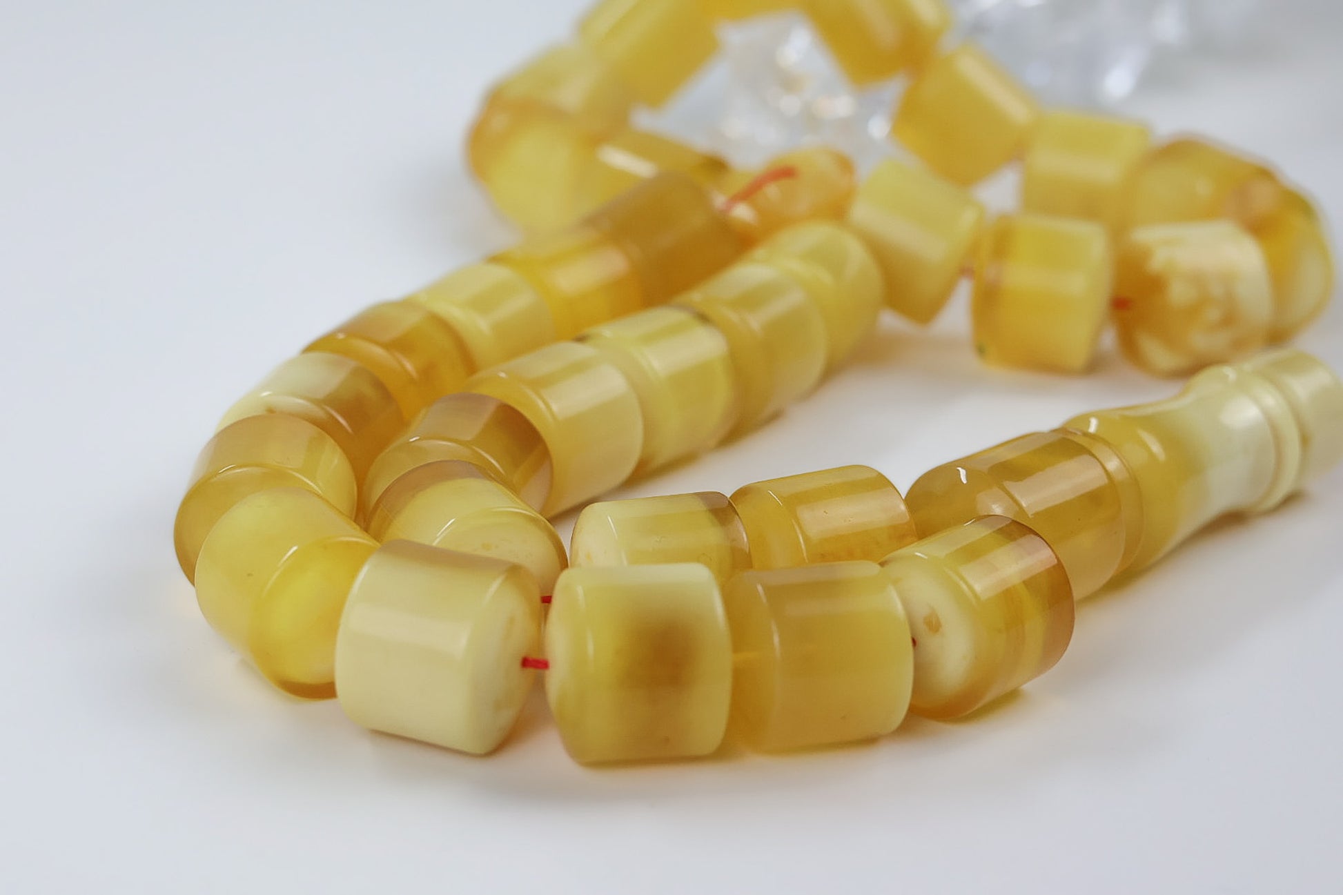 Luxury pressed Baltic amber rosary displayed with decorative crystal accent