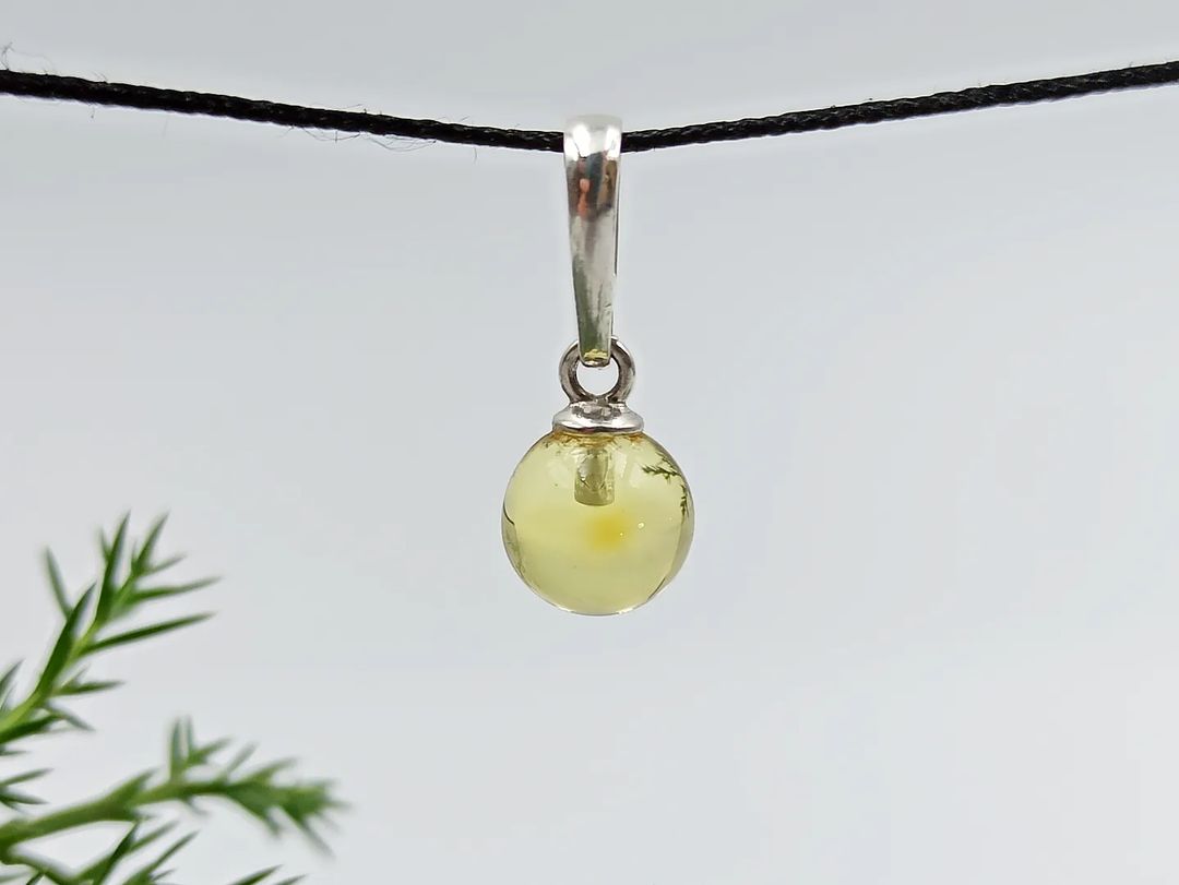 Natural Baltic amber sphere pendant in silver with honey tone