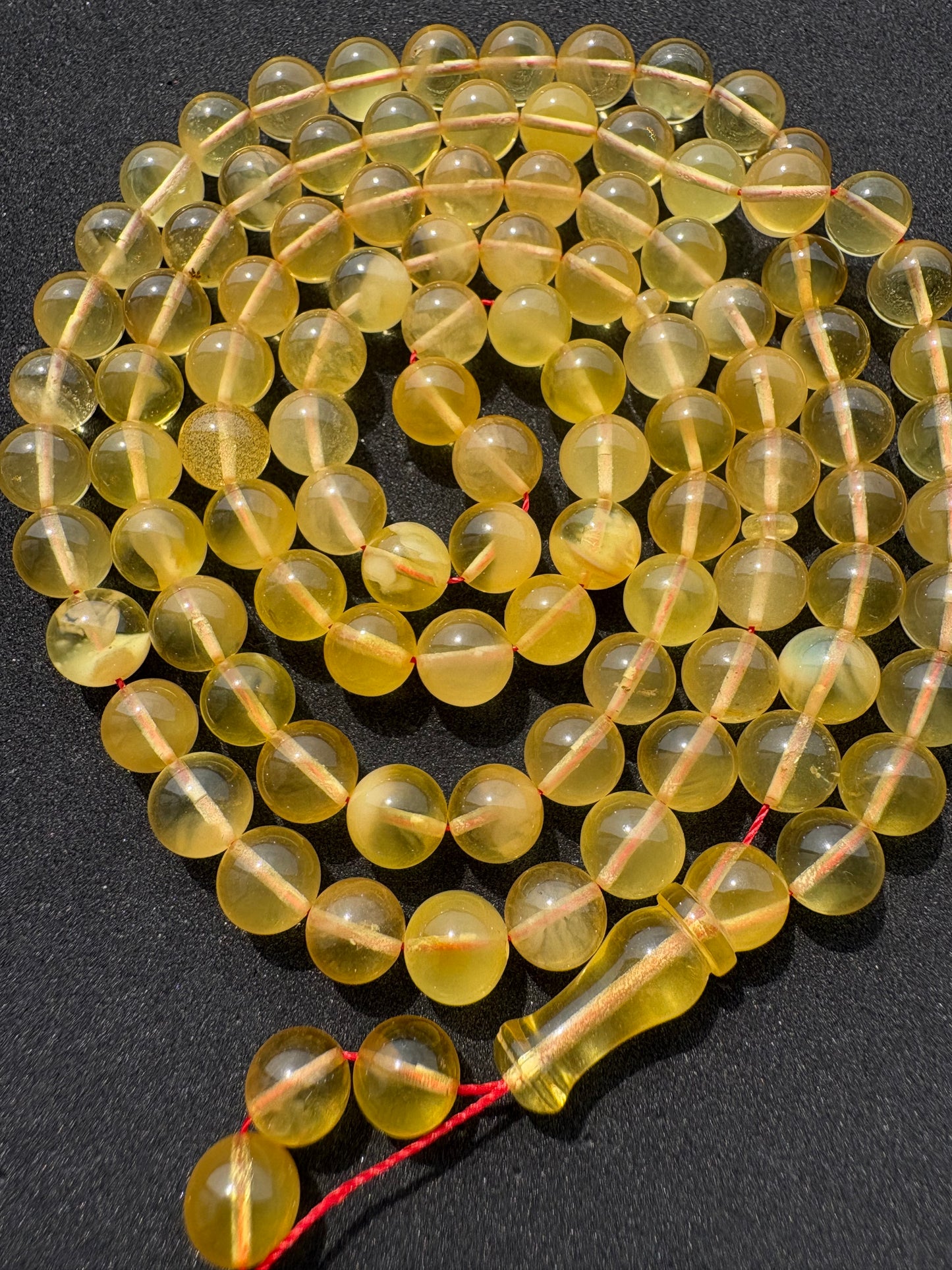 Natural Baltic amber Tesbih with 102 transparent round lemon-yellow amber beads.