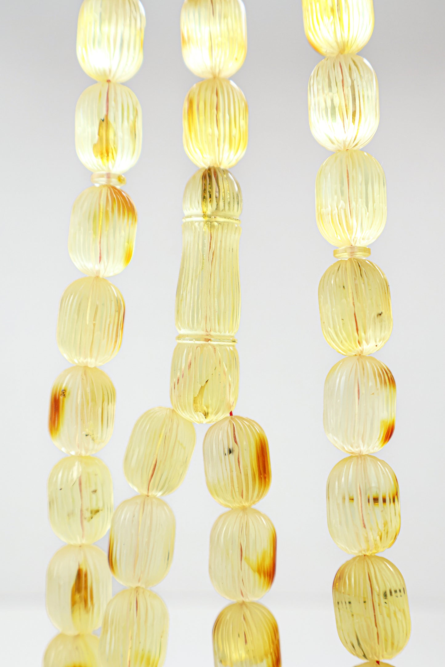 Certified natural hand-carved translucent yellow and brown Baltic amber misbaha rosary with 42 beads measuring 16x12 mm by Tetibel.