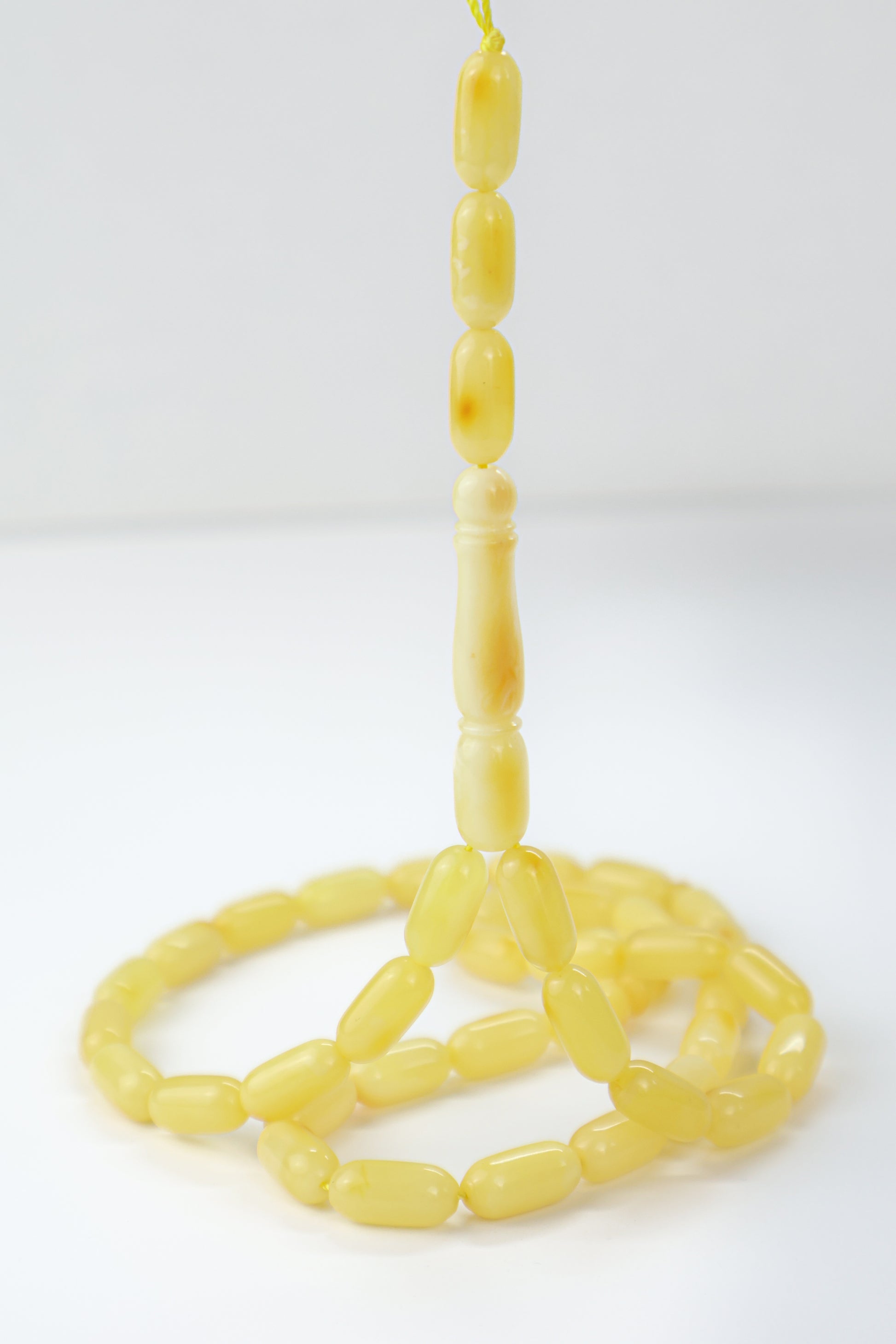 Genuine Baltic amber Mesbah featuring creamy lemon-yellow opaque amber beads.