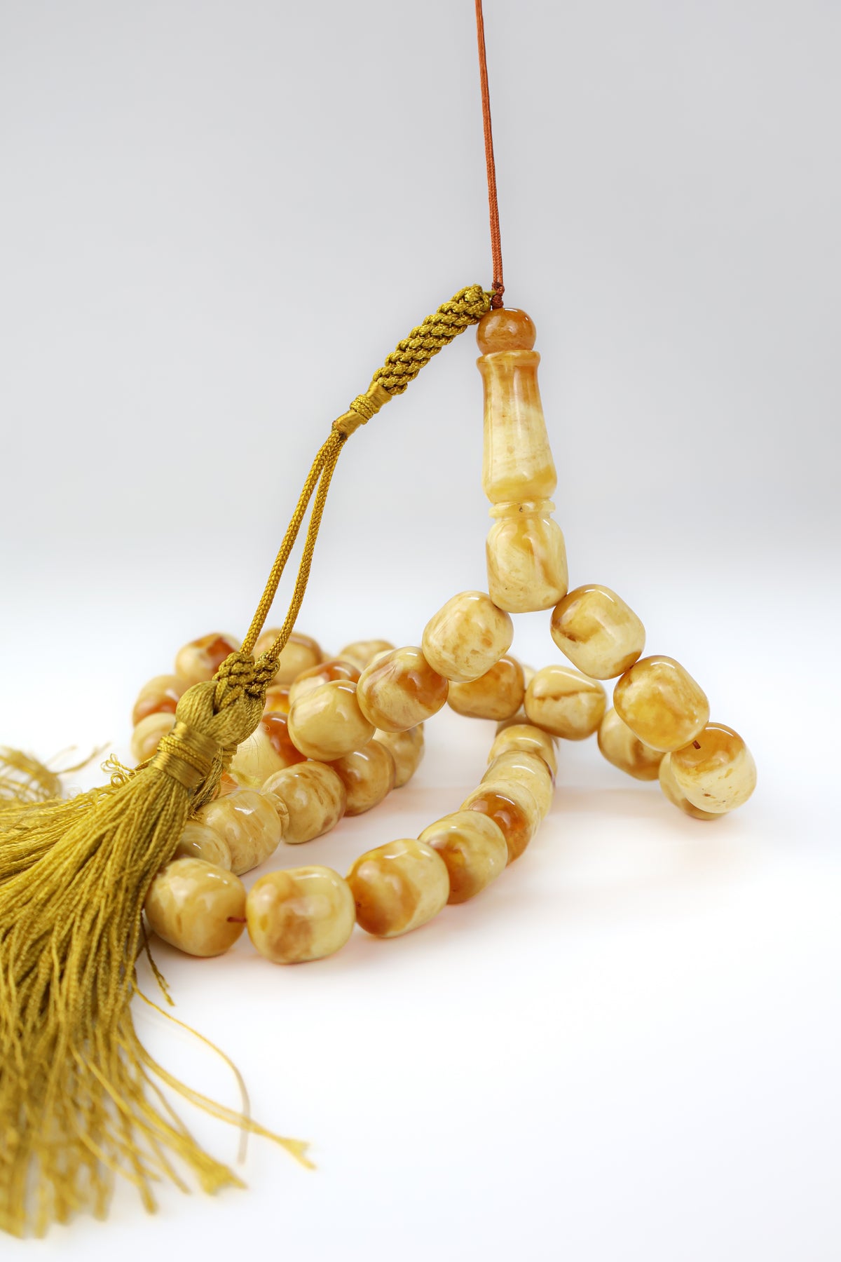 Certified orange and beige Baltic amber misbaha rosary with 42 beads measuring 13.5x12 mm and golden tassels by Tetibel.