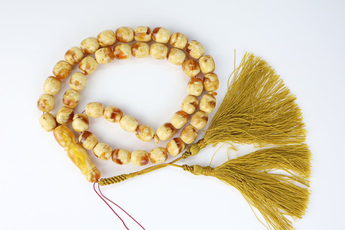 Handcrafted orange and beige succinite amber tasbih featuring 42 authentic 13.5x12mm pressed beads, weight 65.48 grams.