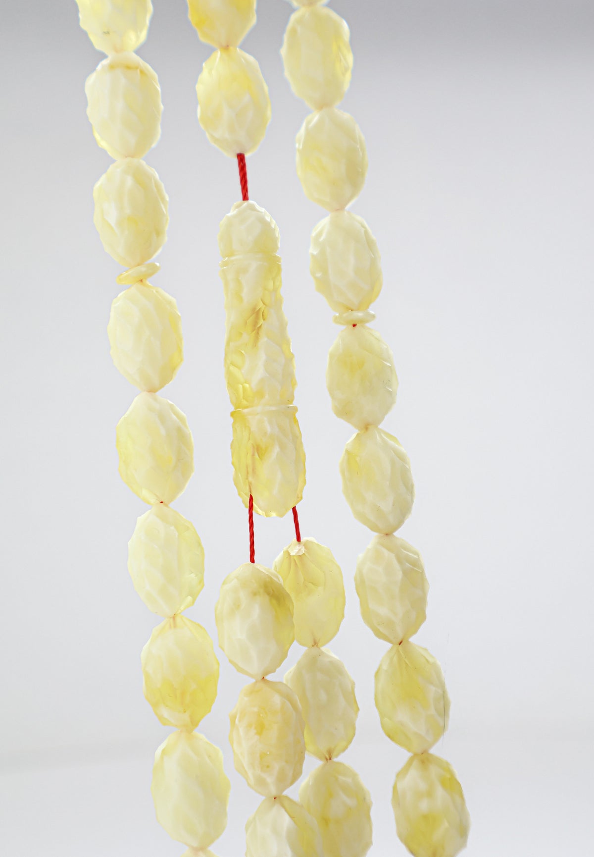 Certified hand-carved yellow and white Baltic amber misbaha rosary with 48 beads measuring 15.5x10 mm by Tetibel.