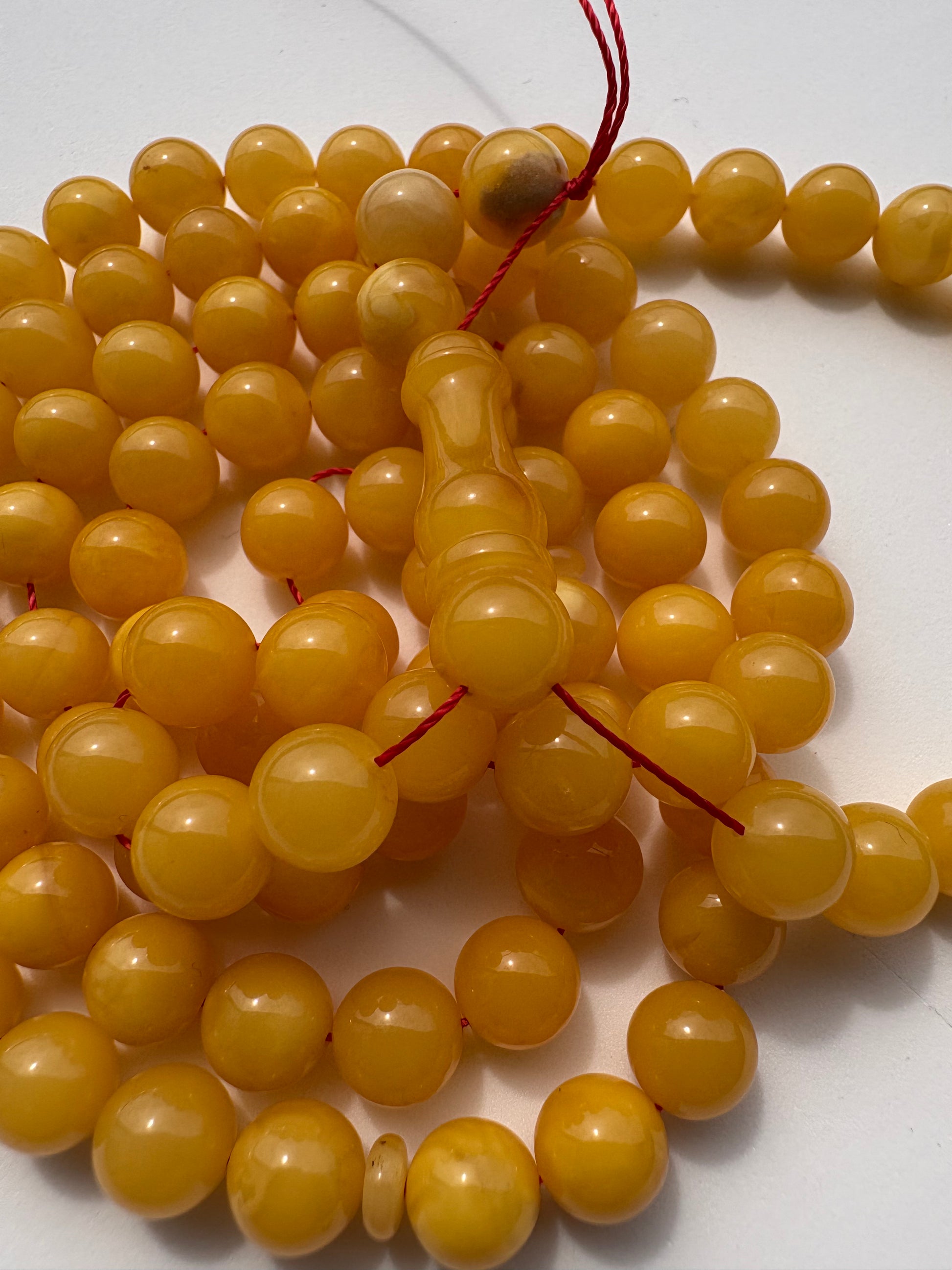 Authentic succinite amber prayer beads with naturally matured mango tone.