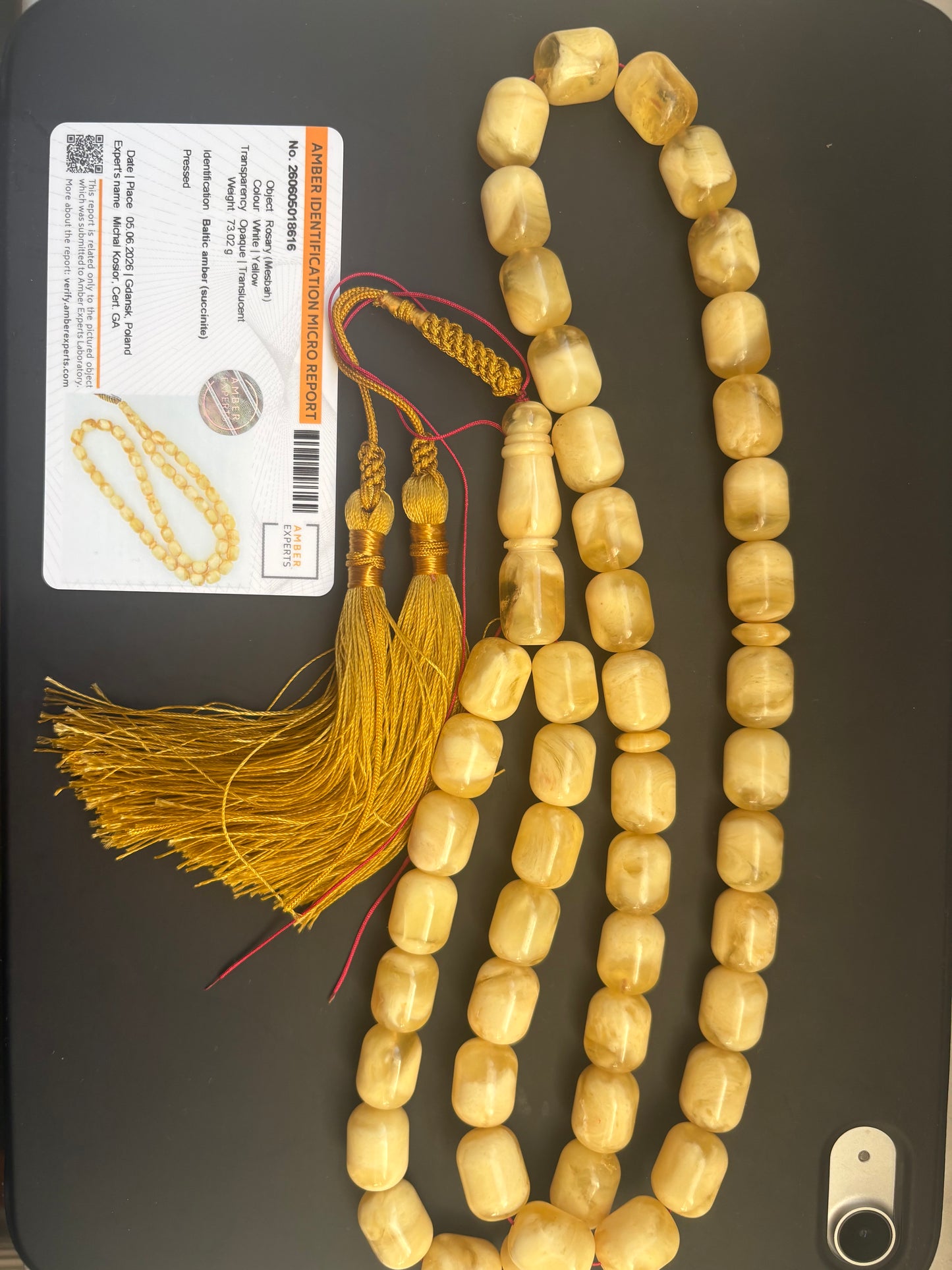 Tetibel 48-bead pressed Baltic amber rosary with 11.5x14.5mm white-yellow barrel beads and a handmade golden tassel from Doha.