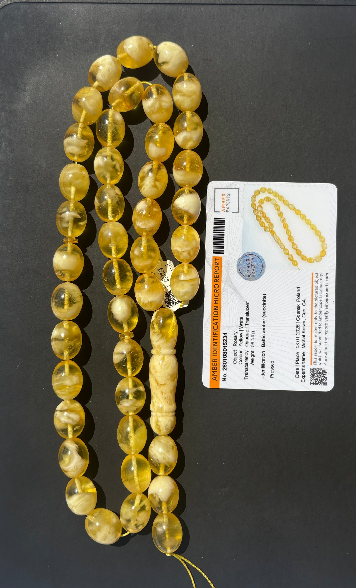 Tetibel 42-bead pressed Baltic amber rosary with 15x12mm yellow and white marbled oval beads and an official authenticity certificate.