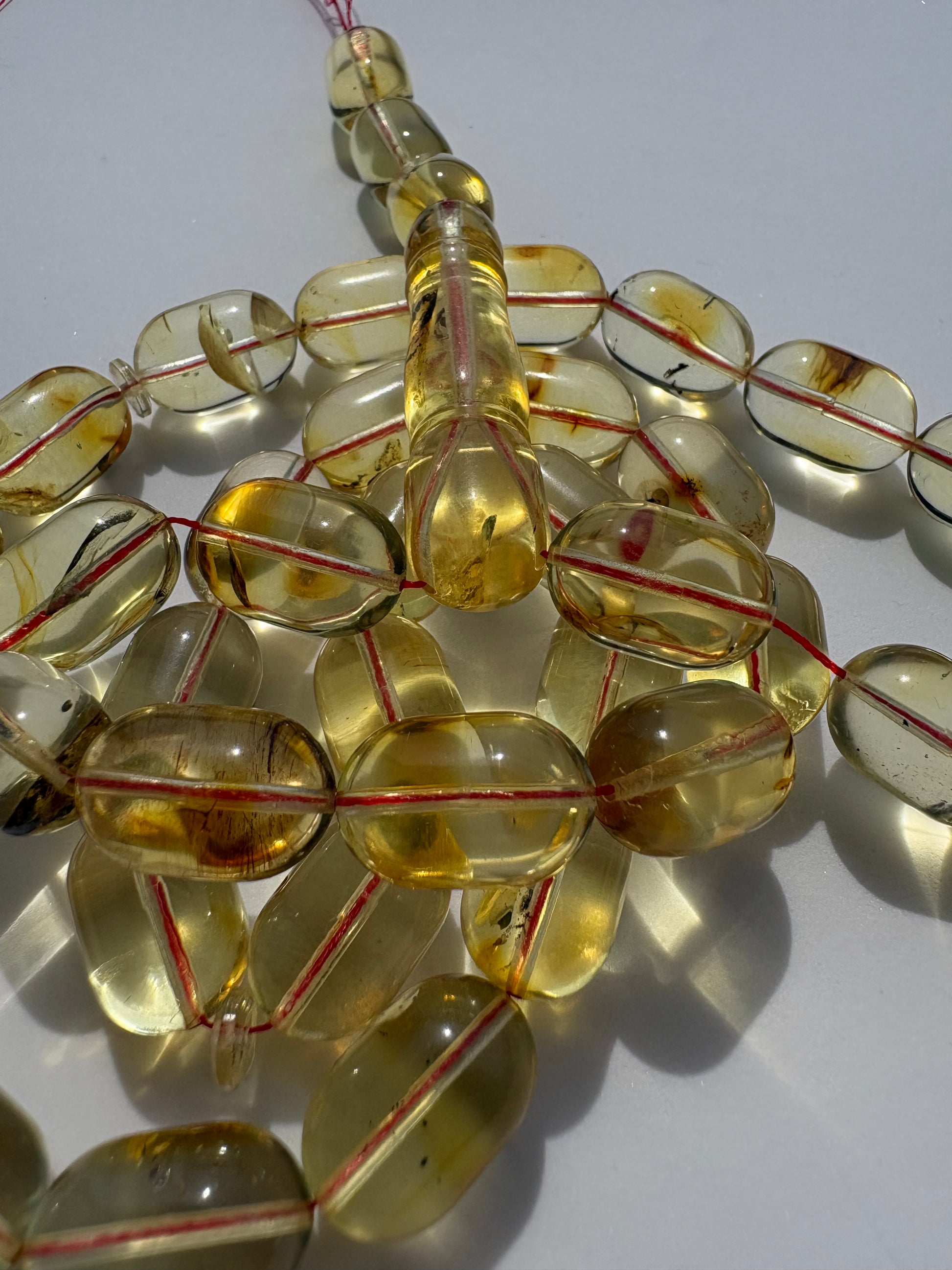 Genuine succinite amber prayer beads in transparent lemon honey color.