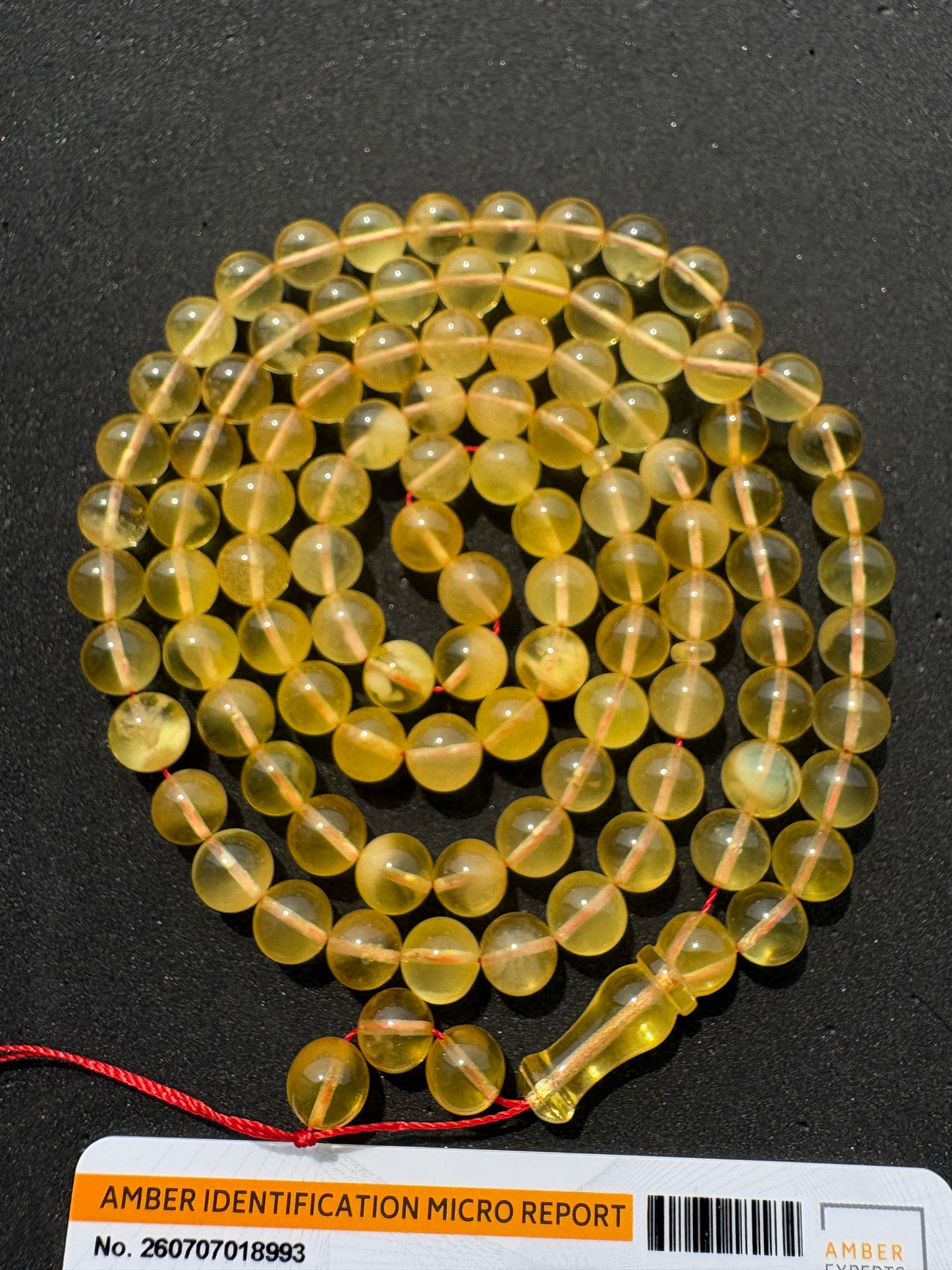 Certified Baltic amber Misbaha featuring 7.7 mm polished spherical beads.