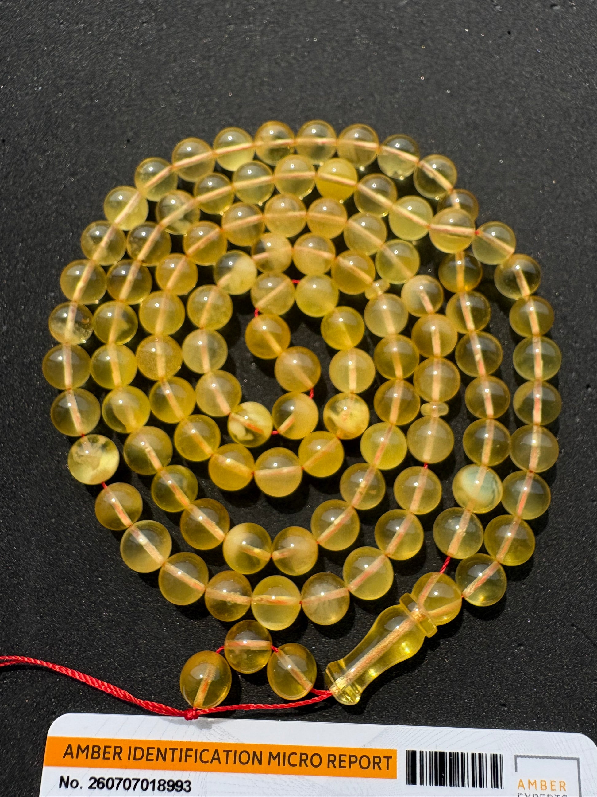 Certified Baltic amber Misbaha featuring 7.7 mm polished spherical beads.